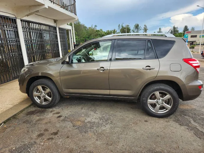 Toyota RAV4 compact 4x4 SUV parked on a smooth paved road in downtown Kigali, showcasing a high-value budget car rental Rwanda vehicle asset