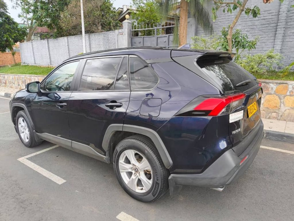Toyota RAV4 compact 4x4 SUV parked on a secure paved driveway in Kigali, showing a premier choice for an extended long term car rental Rwanda lease